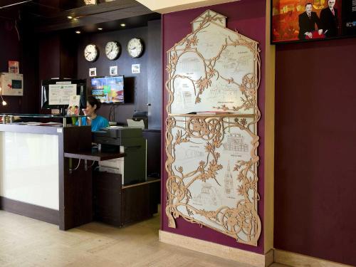 a large clock is on the wall in a store at ibis Styles Nantes Centre Place Royale in Nantes