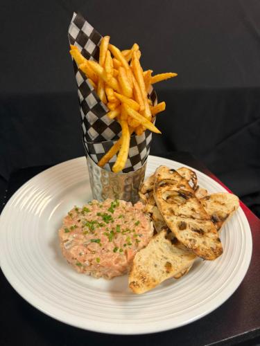 a plate of food with a hamburger and french fries at Holiday Inn Montreal Longueuil by IHG in Longueuil