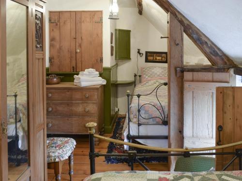 a bedroom with a bed and a dresser in a room at Threshing Barn - Kza in Glaisdale