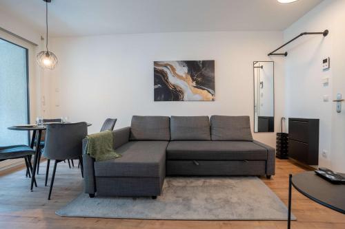 a living room with a couch and a table at CasaVia BB03 with parking up to 4 people kitchen central in Böblingen