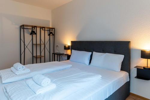 a bedroom with a large bed with two white pillows at CasaVia BB03 with parking up to 4 people kitchen central in Böblingen