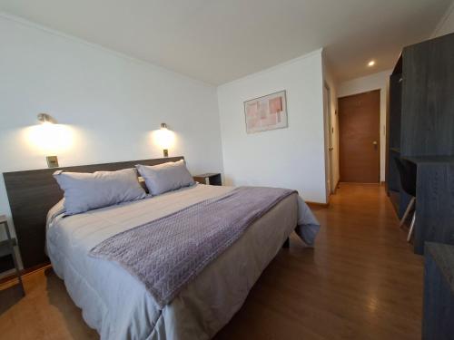 a bedroom with a large bed with two pillows at Hotel Los Andes in Los Andes