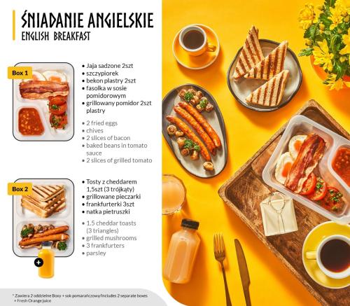 a table with a plate of food and a plate of food at NEMO Deluxe - 3 min od plaży i parking by Lion Apartments Sopot in Sopot