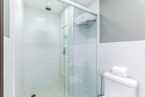 a bathroom with a glass shower and a toilet at Wyndham Sao Paulo Ibirapuera Convention Plaza in Sao Paulo