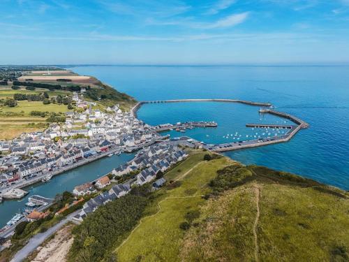 an aerial view of a harbor with boats in the water at ibis Bayeux Port En Bessin in Port-en-Bessin-Huppain