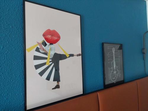 a framed picture of a man with a umbrella at ibis Bayeux Port En Bessin in Port-en-Bessin-Huppain