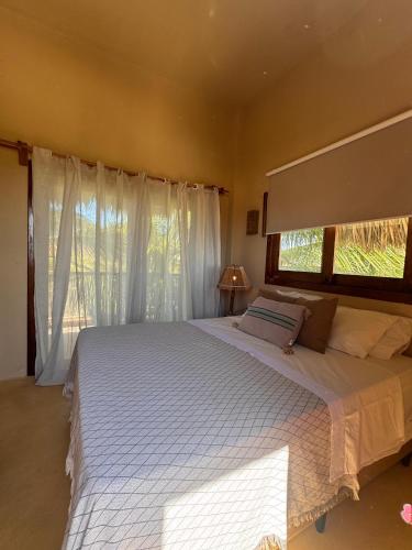 a bedroom with a large bed and a window at Avra Tatajuba in Tatajuba