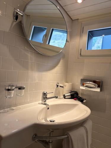 a bathroom with a sink and a mirror at Chalet Annelis Apartments in Zermatt