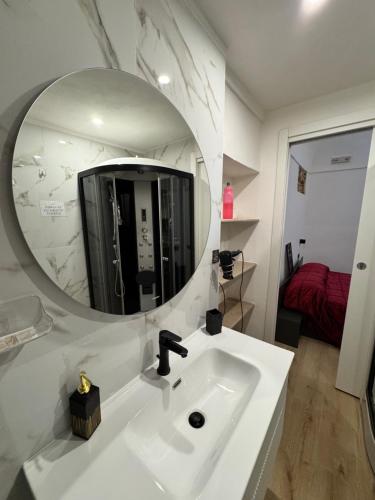 a bathroom with a white sink and a mirror at Spago rooms 2 in Vieste