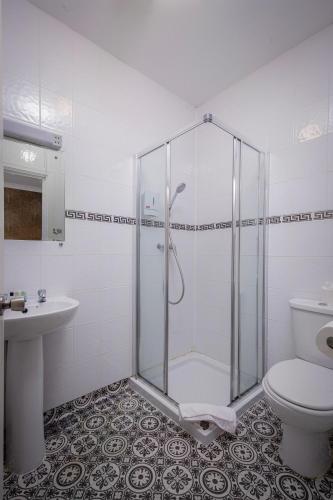 a bathroom with a shower and a toilet and a sink at Ashley Victoria in Blackpool