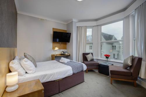 a hotel room with a bed and a window at Ashley Victoria in Blackpool