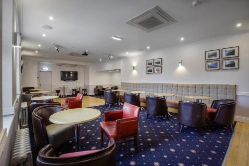 a restaurant with tables and chairs in a room at Ashley Victoria in Blackpool