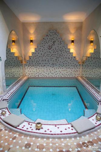 a large swimming pool in a room with at Riad Zoraida in Marrakech