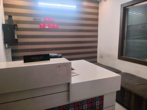 a room with a desk and a window and a couch at Hotel O Zirakpur City Court Complex Formerly The Platinum in Zirakpur