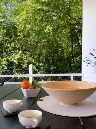 a bowl on a table with some oranges on it at Vila Conceptt casa in Jasenak