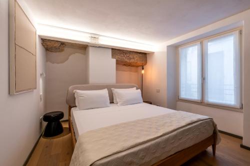 a bedroom with a bed and a large window at Residenza Wega - Luxury Apartments Verona in Verona
