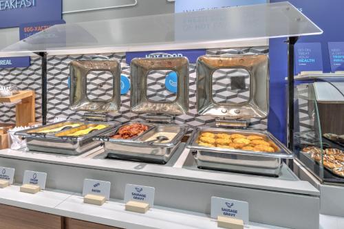a display case with various pastries and other food items at Holiday Inn Express and Suites Granbury by IHG in Granbury