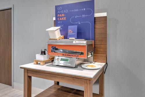 a machine sitting on a table with a plate at Holiday Inn Express and Suites Granbury by IHG in Granbury