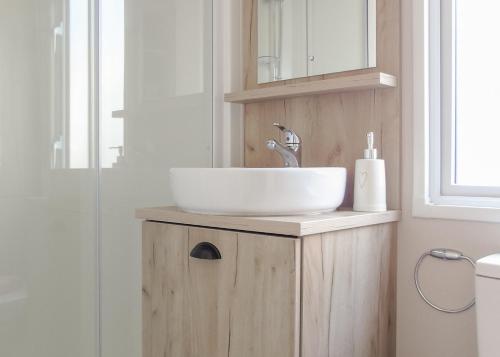 a bathroom with a sink on a wooden cabinet at Fir Trees in Chester
