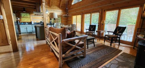 a kitchen and living room with a table and chairs at The Bigwitch Cabin in Cherokee