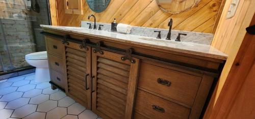 a bathroom with a sink and a toilet at The Bigwitch Cabin in Cherokee
