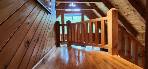 an overhead view of a wooden staircase in a cabin at The Bigwitch Cabin in Cherokee