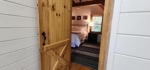 a door leading to a bedroom in a tiny house at The Bigwitch Cabin in Cherokee