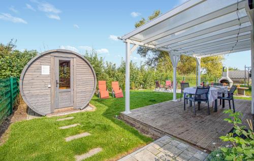a circular hobbit house with a table and a white canopy at Amazing Home In Wandlitz With Sauna in Wandlitz