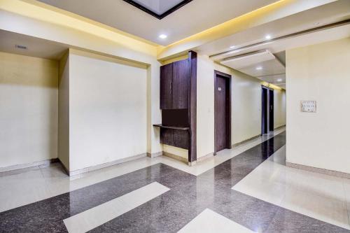 a hallway with white walls and a ceiling at FabExpress Sun n Shine in Pune