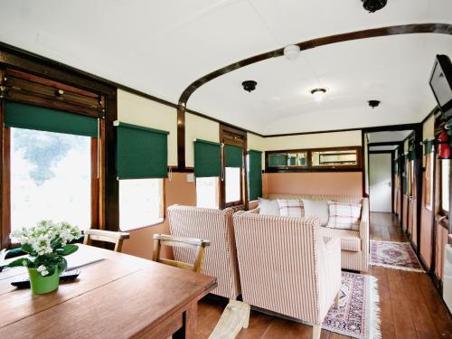 a dining car of a train with a table and chairs at Railway Carriage Two - E5601 in Wetheringsett