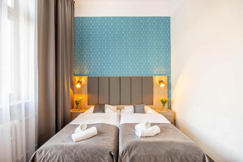 a bedroom with two beds with towels on them at Hotel Polonia Centrum in Wrocław