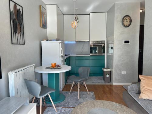 a kitchen with a table and chairs in a room at CENTRAL POINT APARTMENT - City centar Zenica- in Zenica