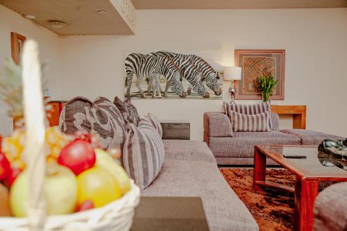 a living room with a couch and a zebra picture on the wall at Elephant Hills Resort in Victoria Falls