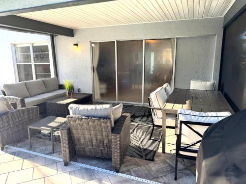 a patio with a couch and chairs and a table at Coastal Escape in Bonita Springs