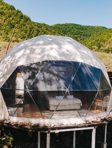 a dome tent on a stand in a field at Glamping Drina Riverzone in Goražde