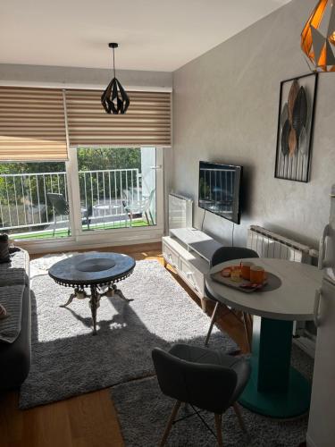 a living room with a couch and a table at CENTRAL POINT APARTMENT - City centar Zenica- in Zenica