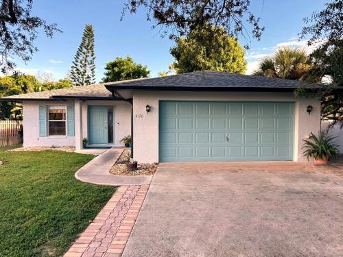 a house with a green garage at Coastal Escape in Bonita Springs