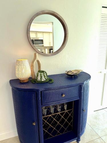 a blue cabinet with a mirror on top of it at Coastal Escape in Bonita Springs