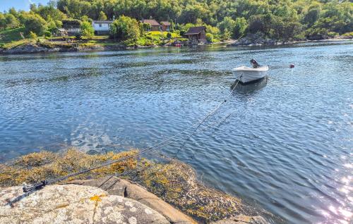 a person in a boat on a river at Stunning Home In Sveio With Wifi in Sveio