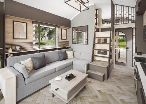 a living room with a couch and a loft bed at Aber Bay Holiday Park in Aberystwyth