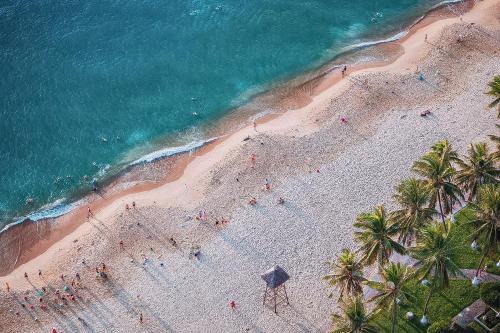 an overhead view of a beach with palm trees and the ocean at Coastal Charm Panorama Bayview in Nha Trang