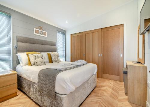 Ένα ή περισσότερα κρεβάτια σε δωμάτιο στο Midsomer Lodges