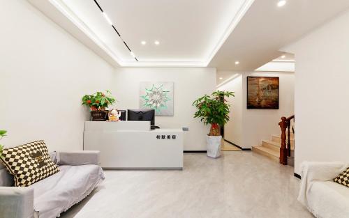 a lobby with a reception desk in a building at 厦门初默民宿 in Xiamen