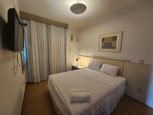 Postel nebo postele na pokoji v ubytování Modernidade e Charme no coração da Savassi