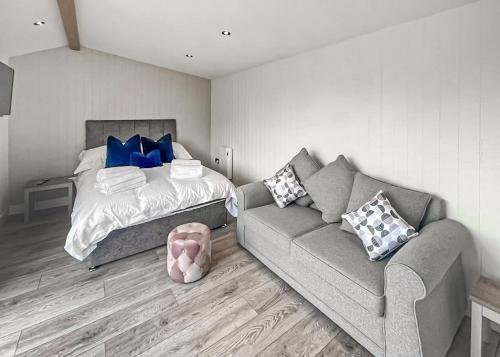 a living room with a couch and a bed at Watermill Leisure Park in Moortown