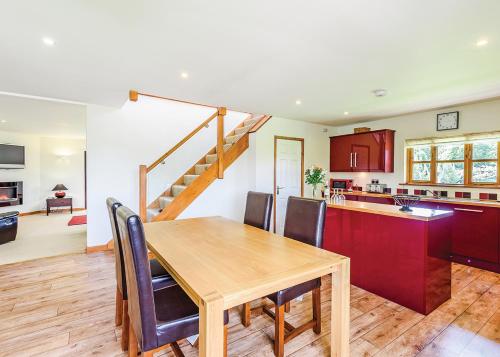 a kitchen and dining room with a wooden table and chairs at Beaconsfield Park in Shrewsbury