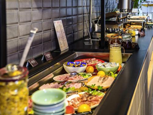 a buffet line with many different types of food at ibis Hotel Muenchen City West in Munich