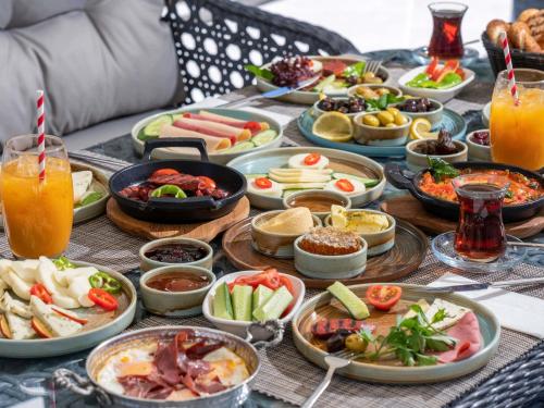 a table with many plates of food and drinks at Novotel Kayseri in Kayseri