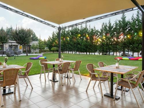 a group of tables and chairs under a tent at Ibis Kayseri in Kayseri