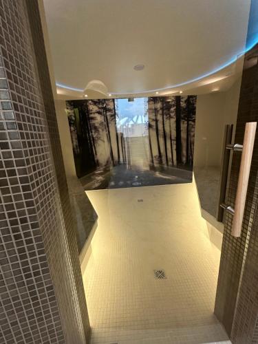 a bathroom with a view of a bathroom with a mirror at PINEA Resort in Pobierowo